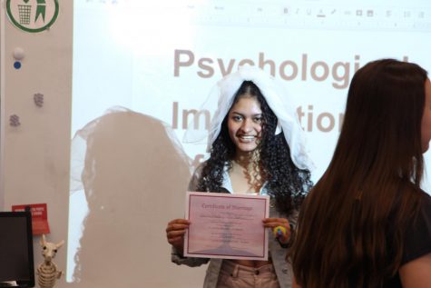 Catherine Hernandez stands with her marriage certificate.