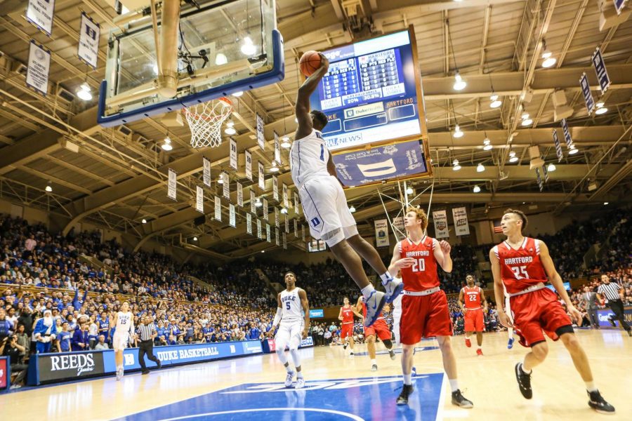 Zion Williamson mid-jump in a game against Hartford University. 