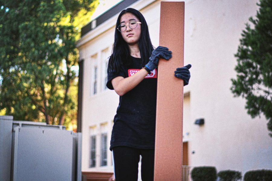 Laying out the new
foundation, Emily Choi (above) and the rest of the Heart of Nature Club help shape the plot of land.