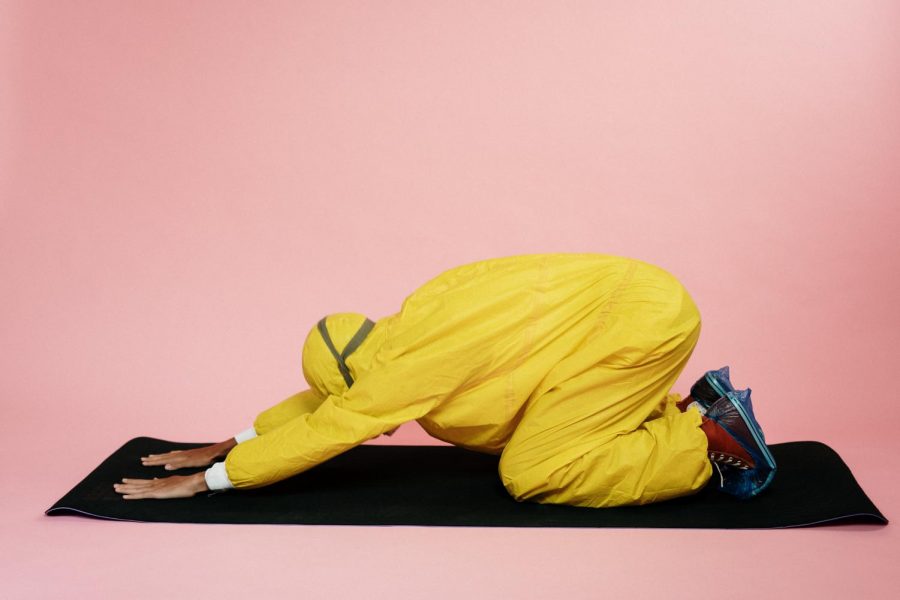 person-in-yellow-protective-suit-doing-a-yoga-pose-3951376