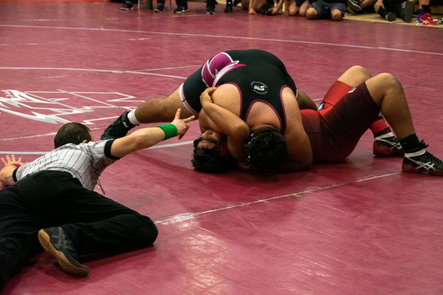 Jesus Rios scores a take down on a wrestler from Madison during the King of the City 2019 wrestling tournament.