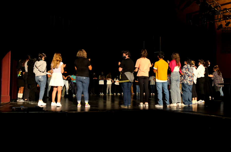 Warming up. Theater teacher Ms. Mollie Lief leads the participants in a warm up session to prepare them for auditions.