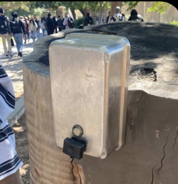 Devilish! An anonymous individual removed a soap dispenser from one of the school’s bathrooms and positioned it on a tree stump in plain view of students. 