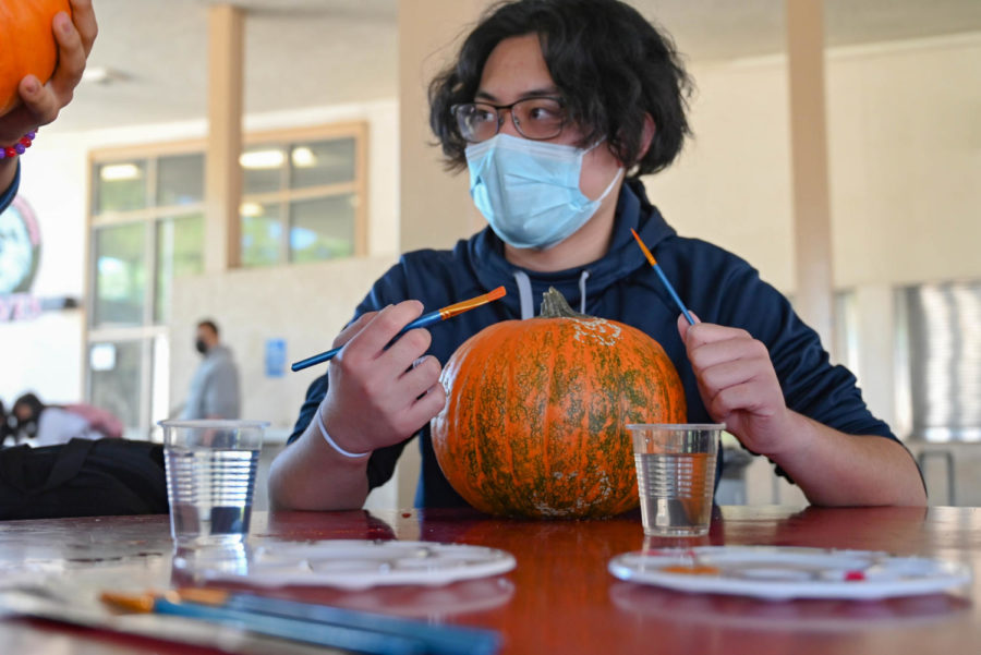 After choosing his perfect pumpkin, Senior Marvin Ocampo prepares a scary idea to paint.