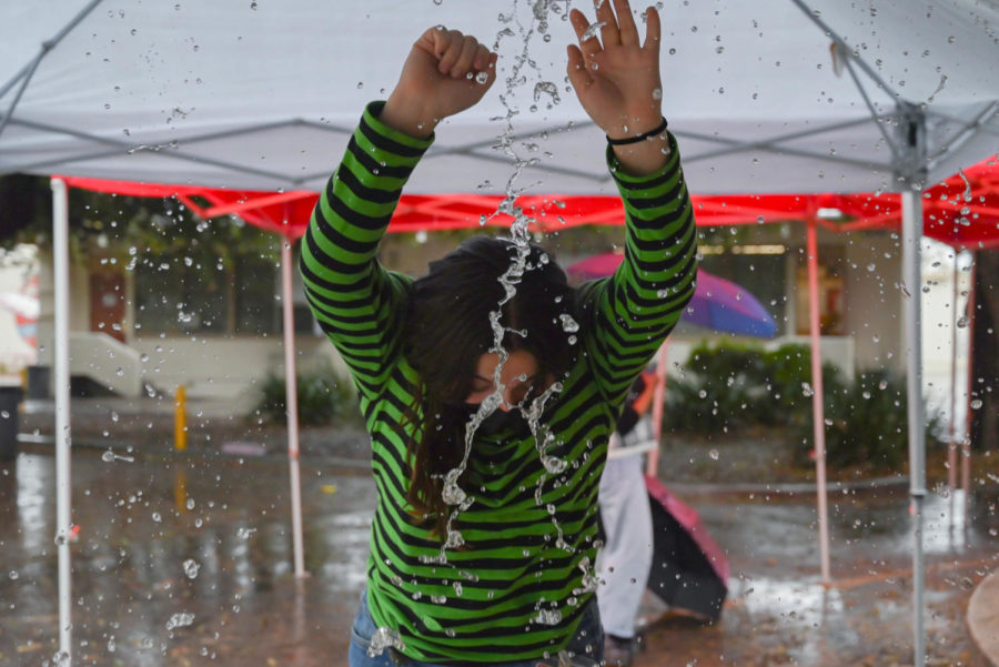 RAIN RAIN GO AWAY: Amidst a sudden, heavy downpour, Senior Angela Proca tries to stay dry under the temporary tents in front of the school cafeteria on Oct. 25. The sudden storm brought brief periods of heavy rain, thunder and even occasional lightning, after a long spell of dry weather. Even though the rain was welcome, it did little to alleviate Southern Californias ongoing historic drought, the longest in 1,200 years.