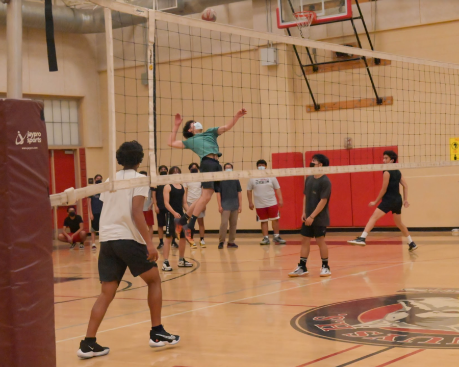 Returning varsity player David Torres leaps in the air to spike the ball.
