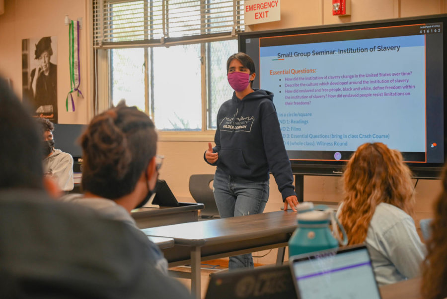 Ms. Doshi leads a discussion on slavery with her junior students. 