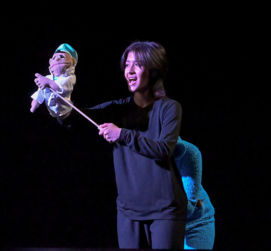 Junior Destiny Reevels as Walter performs Man or Muppet with a puppet from the 2011 Disney musical “The Muppets.”