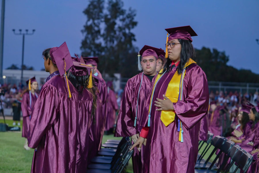 Graduate Joshua Estrada waits for his name to be called to receive his diploma and shake the principal’s hand