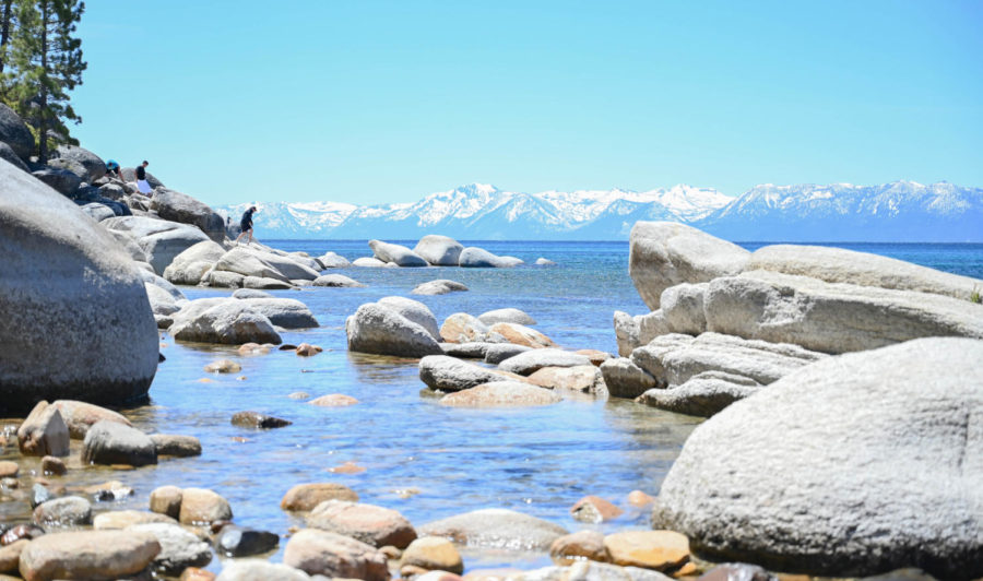  Lake Tahoe is separated by the state line between California and Nevada. The cold lake waters reflect the many mountains and trees that surround the Lake Tahoe State Park