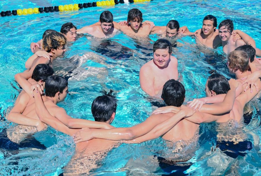 Water+polo+team+members+come+in+for+a+team+huddle+as+they+celebrate+their+victory+against+the+Kennedy+Cougars.
