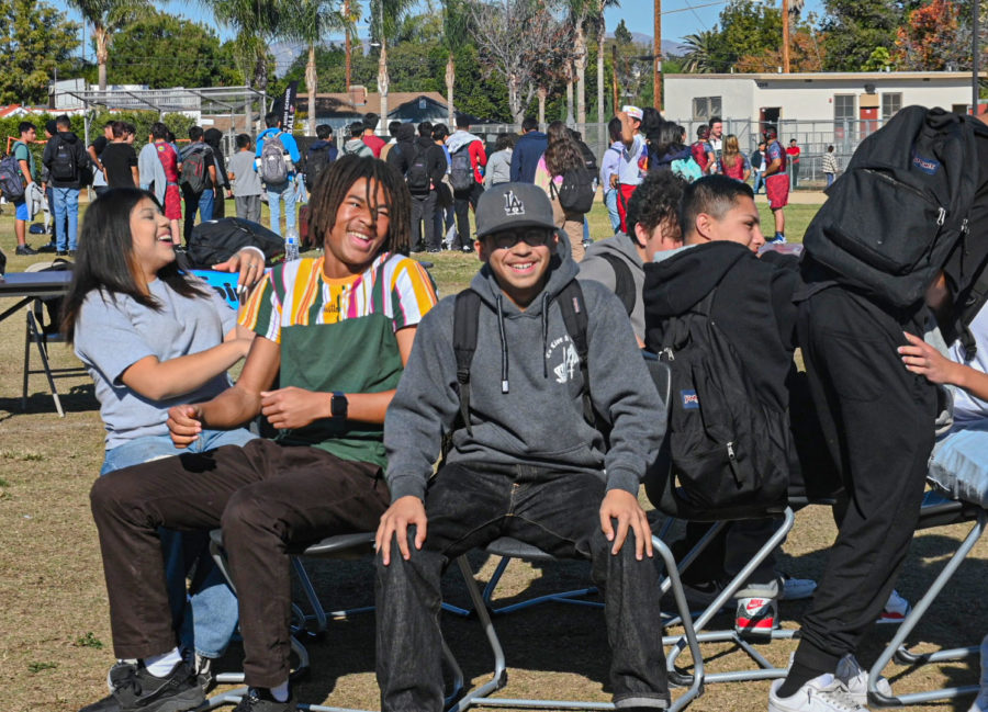 As music plays and chairs are formed into a circle, students participate to play musical chairs and see who gets eliminated throughout the game.
