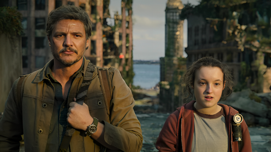 A photo of Ellie (Bella Ramsey) and Joel (Pedro Pascal) looking out into the horizon. 