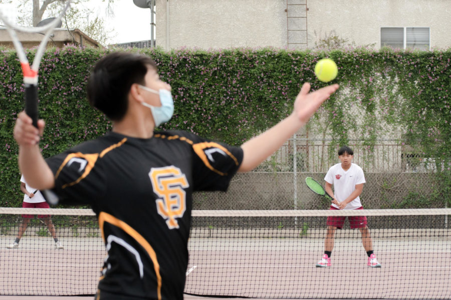 A San Fernando Tiger gets ready to serve the ball to Eric Heng, who won his set. 