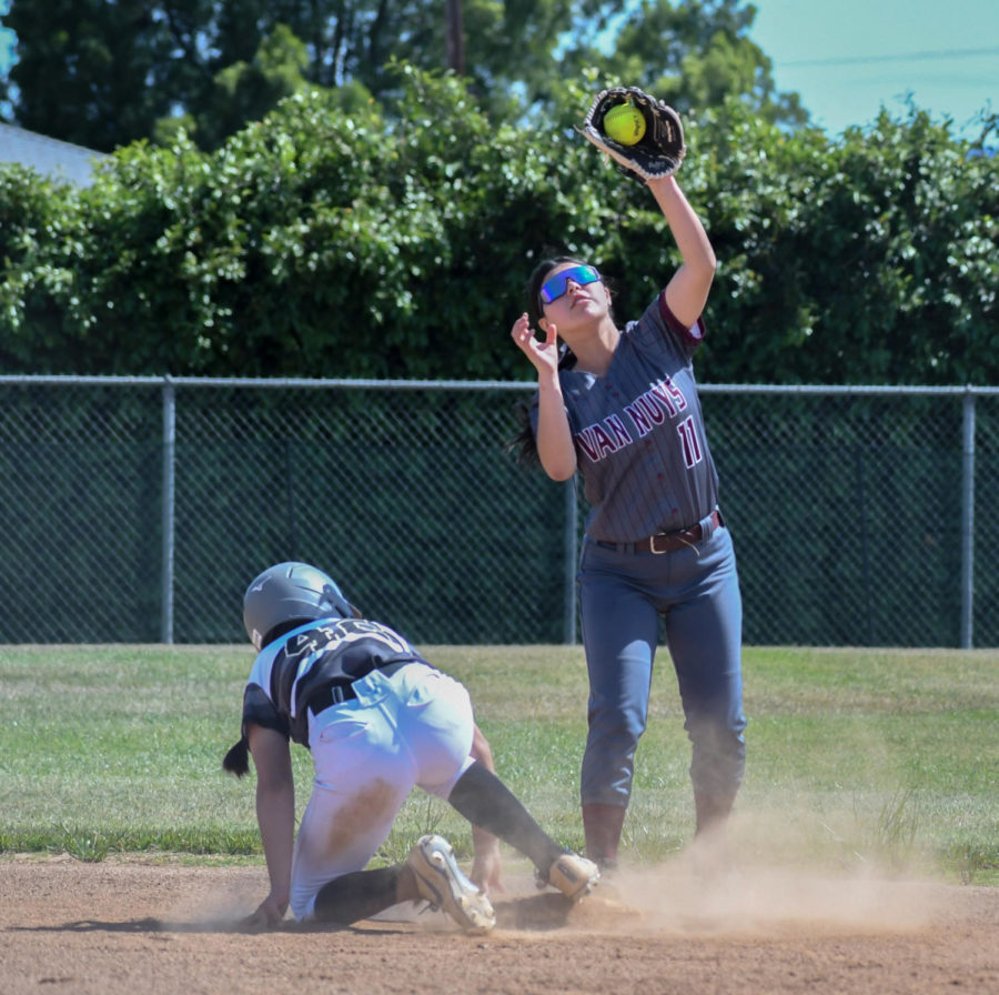 Ariel Puente, #11 catches the ball at second, trying to get the runner out.