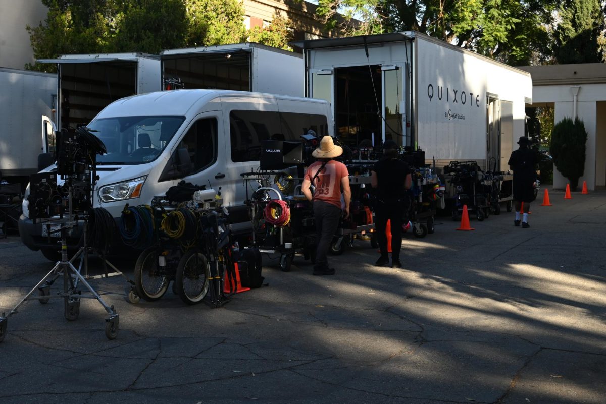 A group of filming trucks parked outside the main building, with a film crew unloading various pieces of equipment Monday and Tuesday.