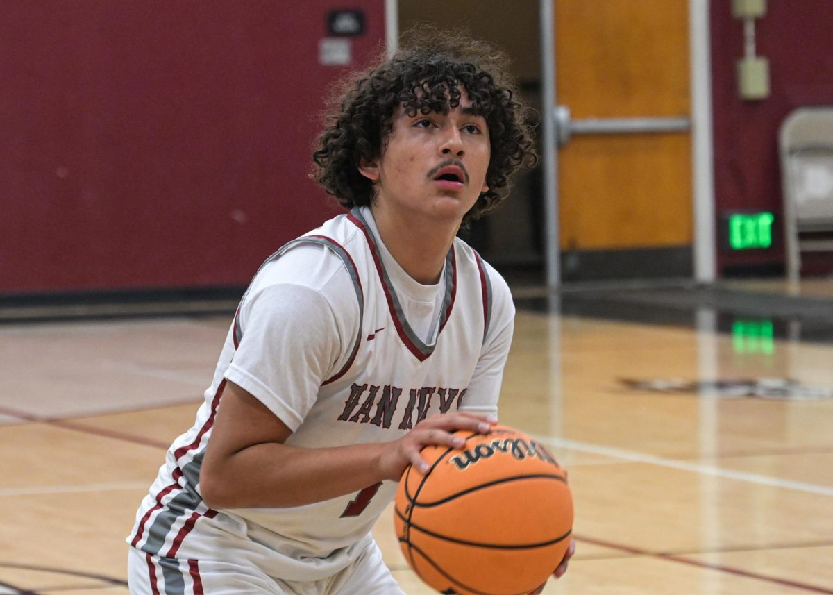 Jeremy Rivas (#1) locks his eyes onto the hoop while shooting a free throw against the SOCES Knights.