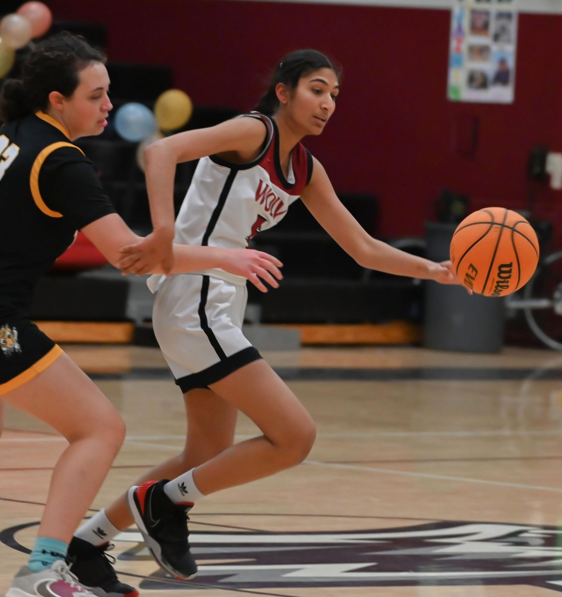 Junior, Karen Grewal successfully gets passed her defender as she runs to score a layup. 