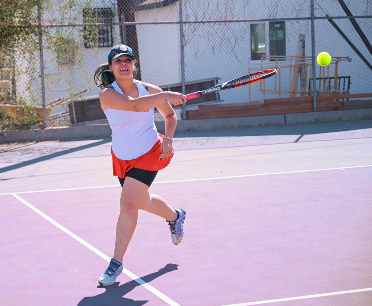 WHACK+IT+WITH+A+RACKET+Ellen+Lalafaryan+lunges+for+a+ball+during+warmups+in+preparation+for+her+match+against+Kennedy.