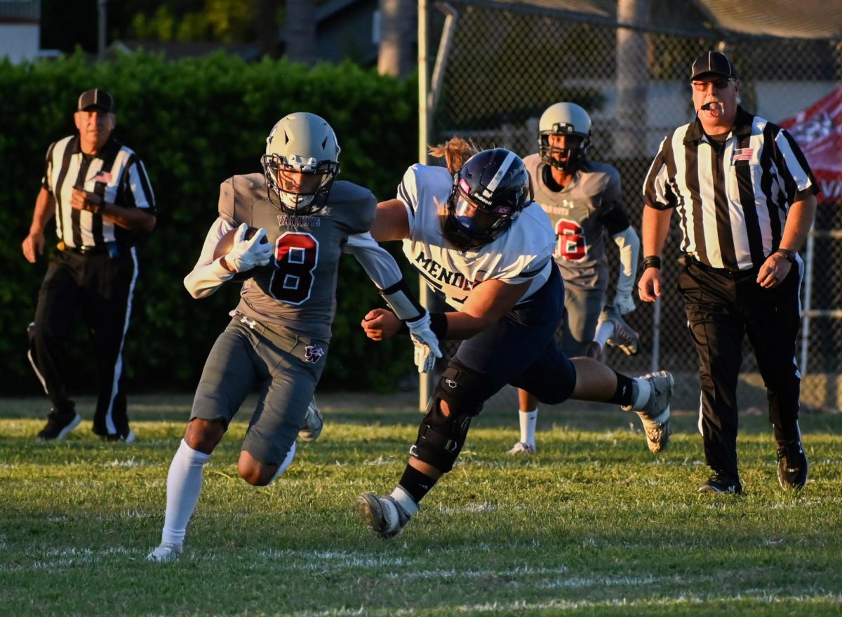 FAST AS LIGHTNING Brandon Arteaga bolts away from a Mendez High player attempting to pull and tackle him.