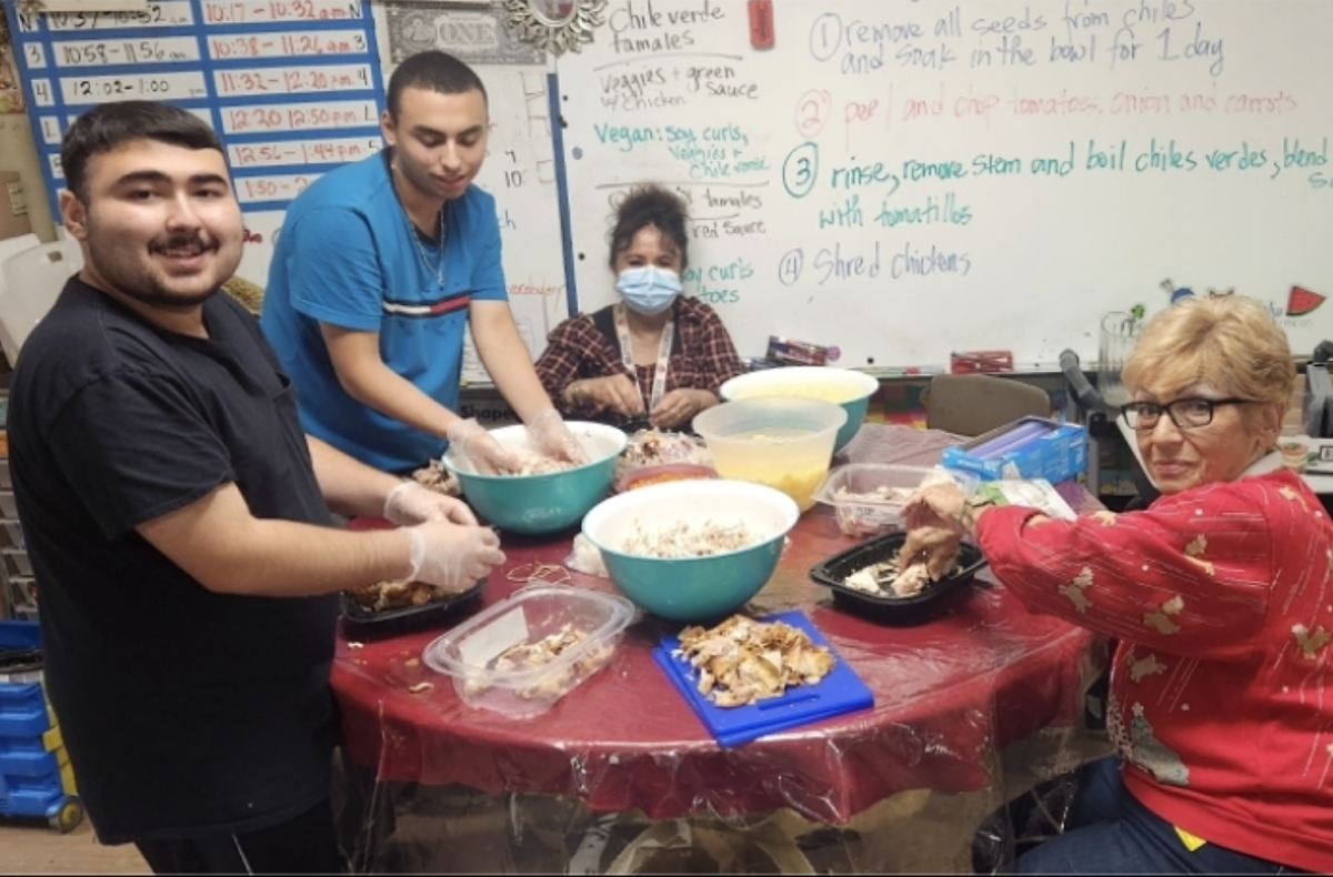 Special Education program students Alexander Salinas (L) and Christopher Gonzalez (second from L), with the assistance of teachers assistants Ms. Hilda Chavez and Ms. Maia Marinho Willman prepare a Thanksgiving feast as a thank you for faculty support of the program. The students aides in the autism program collect aluminum cans, water bottles and glass from classrooms every Wednesday, sort them and then travel to a local recycling center to exchange them for money. <b>COURTESY | SUSANNA VALADEZ</b>