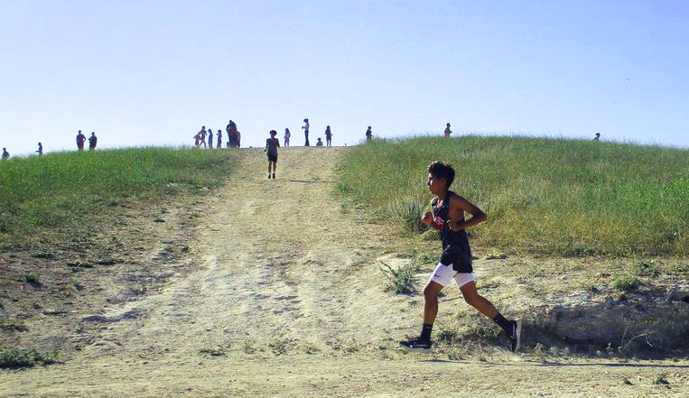 RUN, RUN RUN In the October heat, sophomore Jesse Jose and other runners push through at the Sylmar cross country meet and make it to the finish line.