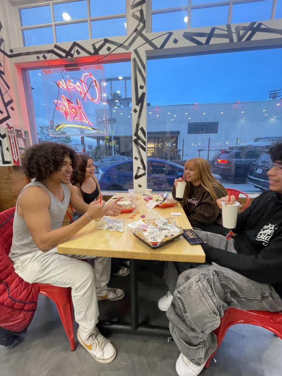 Clockwise, starting from far left: Marlon Figueroa, Aaliyah Vasquez, Djaeda Hall and Walter Rodriguez chat at the Daves Hot Chicken fundraiser.