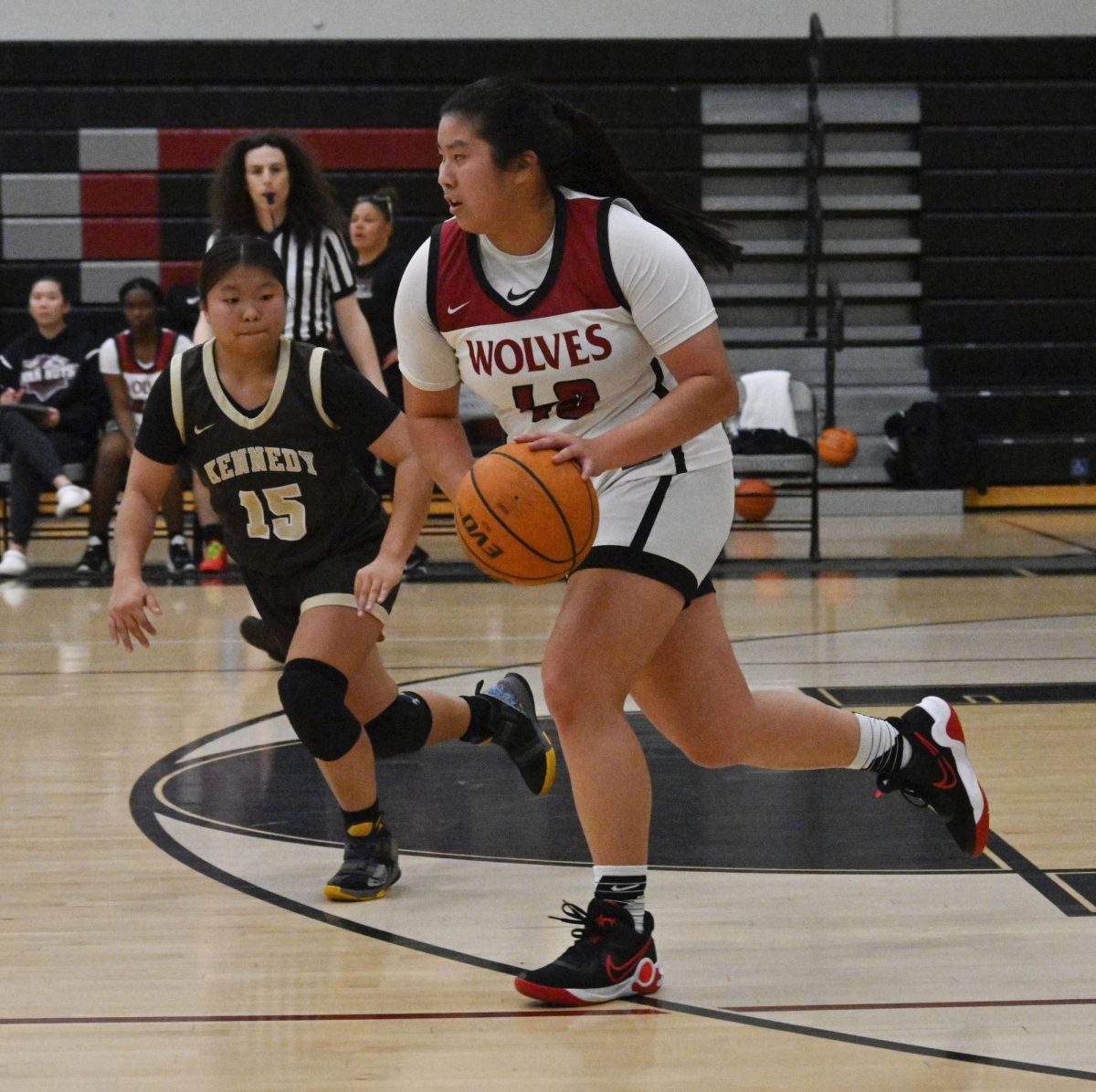 Cara Decathong (#22) protects the ball from the opposing teams player.