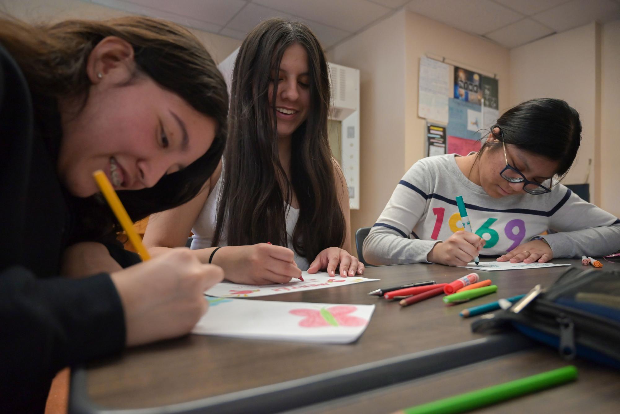 UPLIFTING OTHERS Melanie Arista, Yanitzy Alatorre and Nancy Alvarado (L to R) create cards for the Letters of Love campaign, an initiative working to support migrant children who have been separated from their loved ones in federal detention centers. Arista, a first-generation Mexican-American, founded the club to promote the inclusion of Hispanic and Latin individuals.