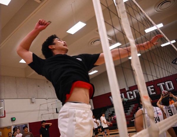Nieco Erasmo practices his volleyball skills during warmup.