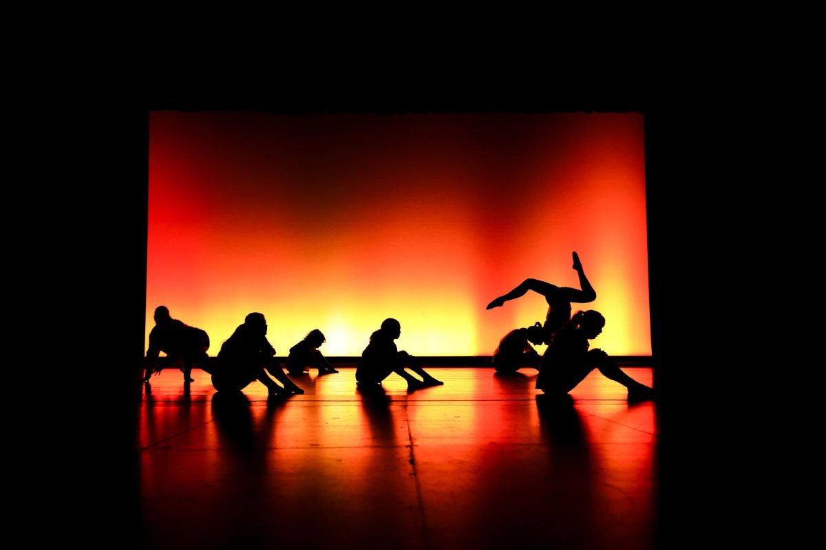 In a silhouetted moment, Ms. Partida's advanced dancers freeze, acting as patients in an insane asylum. (Lighting Design: Ethan Rodda)