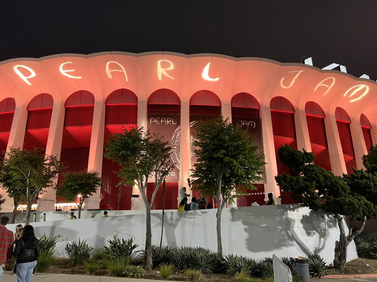 The exterior of the Kia Forum in Inglewood, California shines with a projection of the new logo of the legendary grunge band.