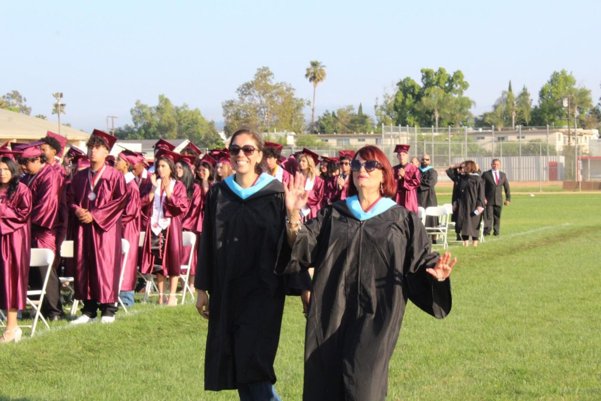 Magnet Coordinators Elizabeth Torres (Medical Magnet) and Fanny Arana (Performing Arts) waved to the graduates as they walked down the field after them.