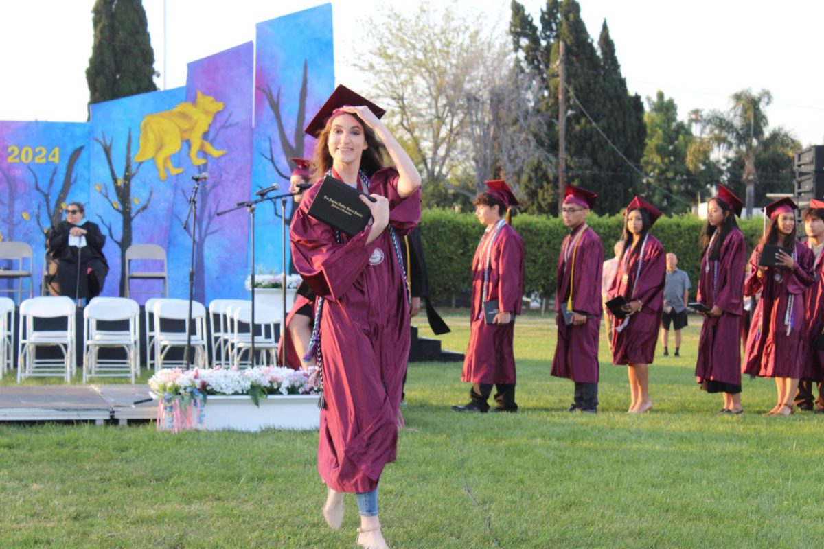The Mirrors Executive Editor-In-Chief Angelina Gevorgyan proudly holds up her diploma, signaling the end of her high school career.