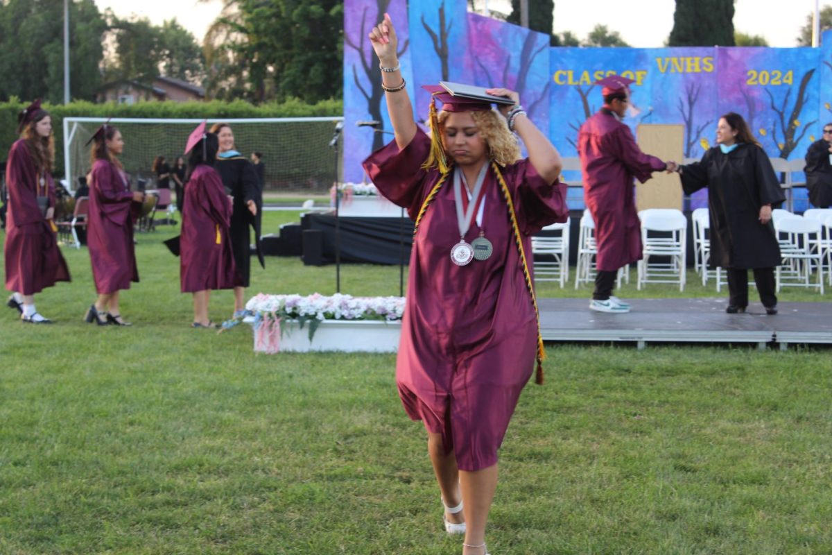 Fresh off the graduation stage, graduate Djaeda Hall dances her way back to her seat.