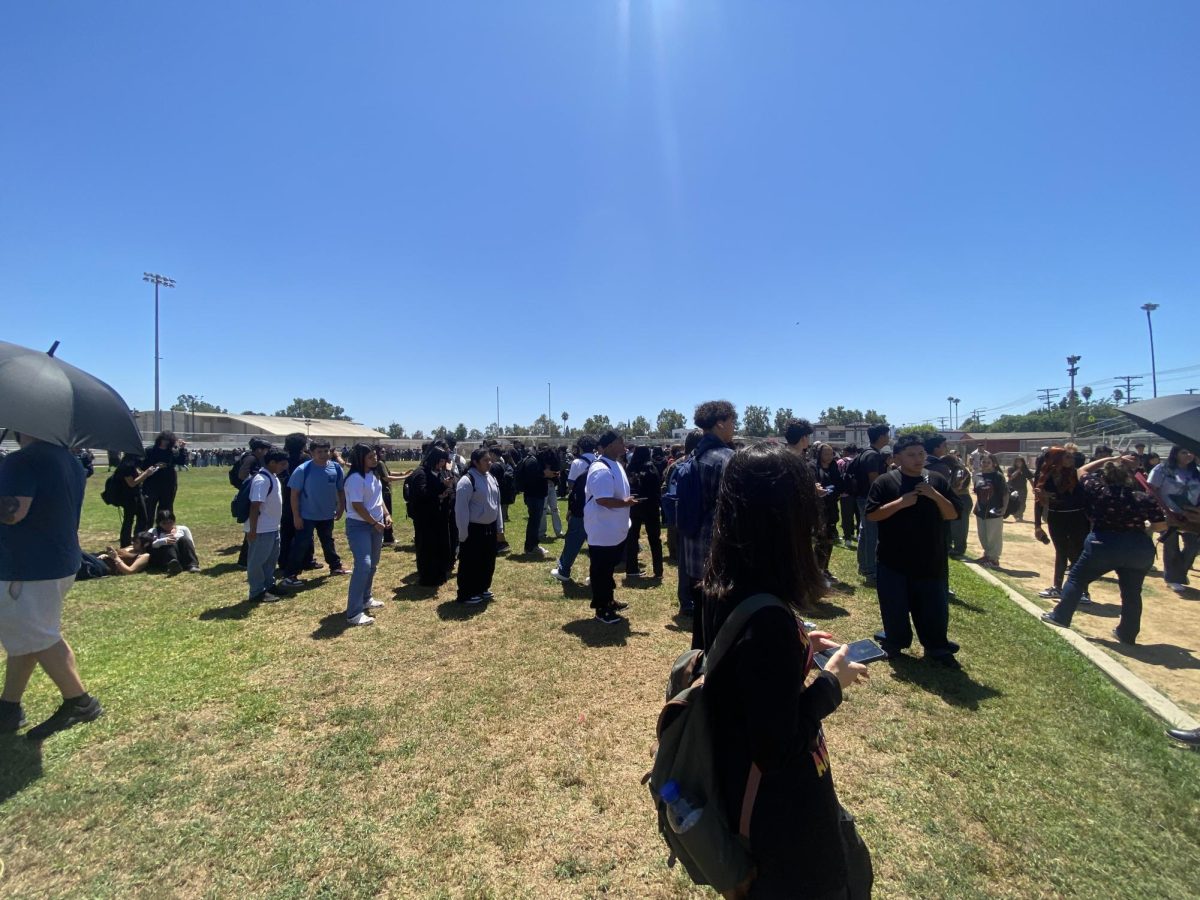 Waiting in the 90 degree heat, students looked to their teachers for instruction.