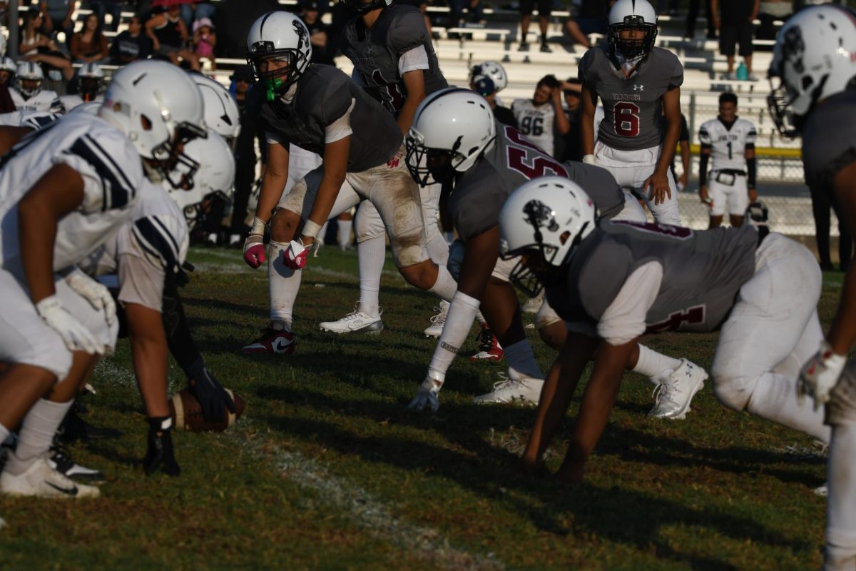 
 Ready, Set, Tackle!  (From L to R) Players William Sizemore, Oscar Urias, and Taner Sungur get into position as they get ready to steal the ball from the Fulton Jaguars. 
