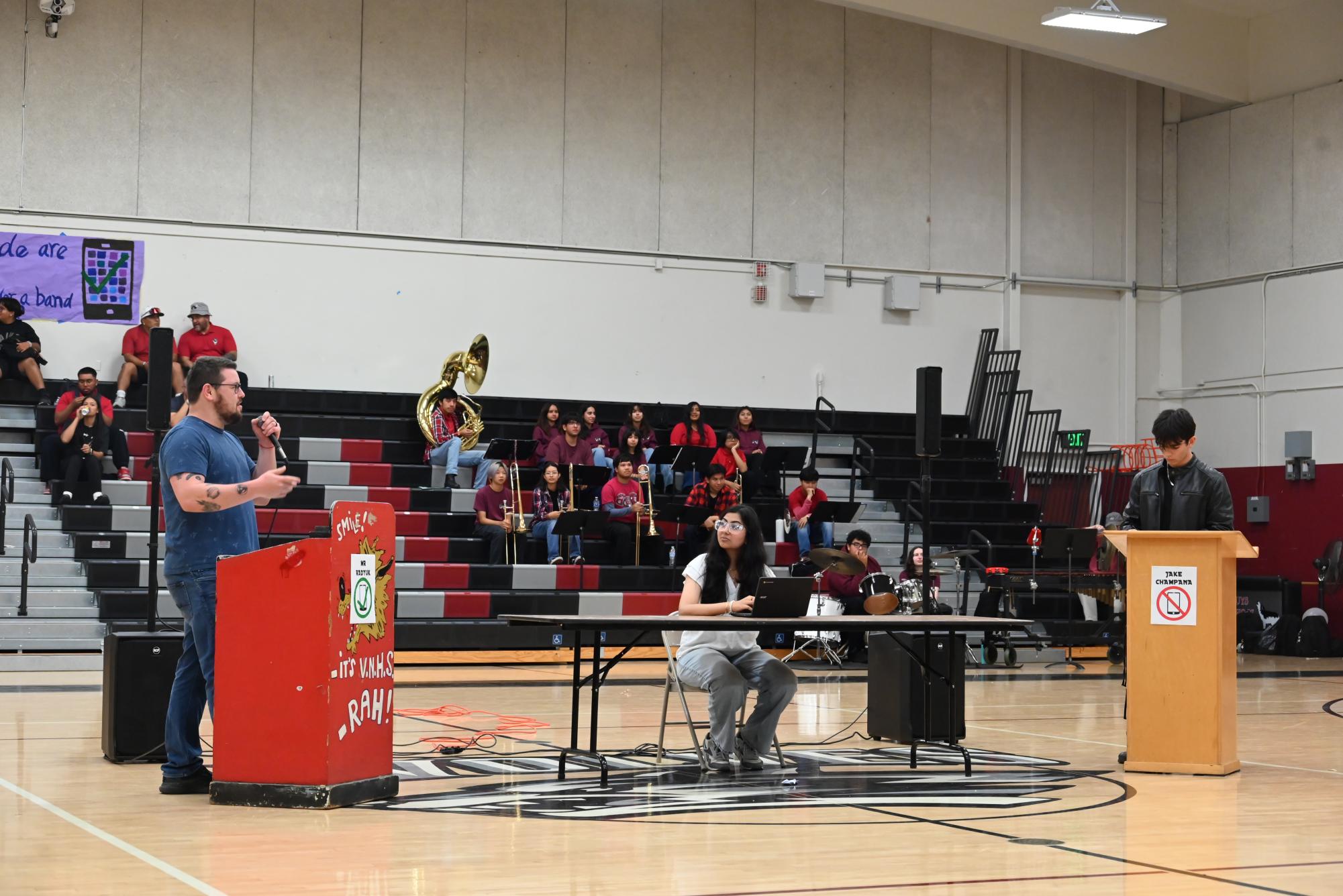 PRO CON: History teacher Mr. David Radyuk (L) listens to a point made by student Jake Champana while the audience looks on at a debate on Sept. 13 that considered whether or not cell phones should be banned at school.  Mr. Radyuk argued against banning phones, while Champana argued for a ban.