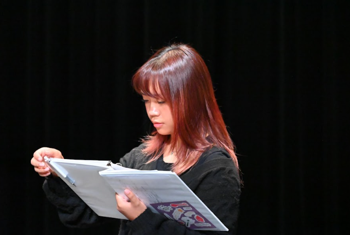 Junior Brianne Tolentino takes notes in her script, marking down blocking, lines and character choices.