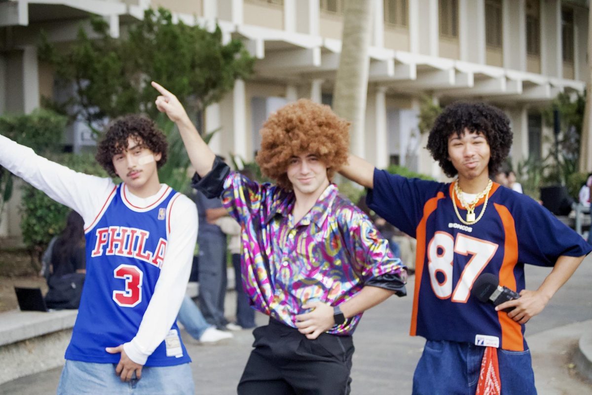 (L-R) Seniors Jeremy Rivas, Hudson Mirsky, and Elijah Loox get into school spirit as they strike a disco pose.