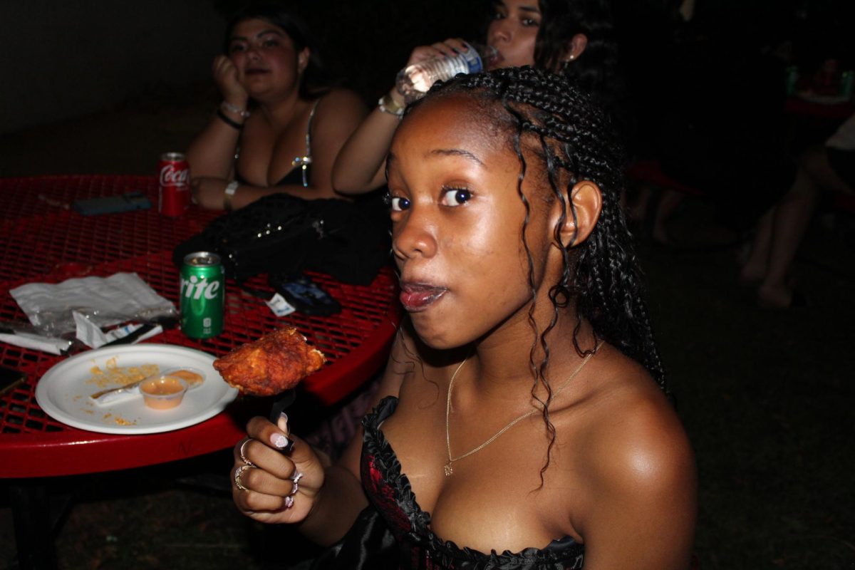 Junior Maya Johnson enjoys her spicy chicken, offered to all the students at homecoming. The event was catered by Daves Hot Chicken, a restaurant choice that had many students excited.