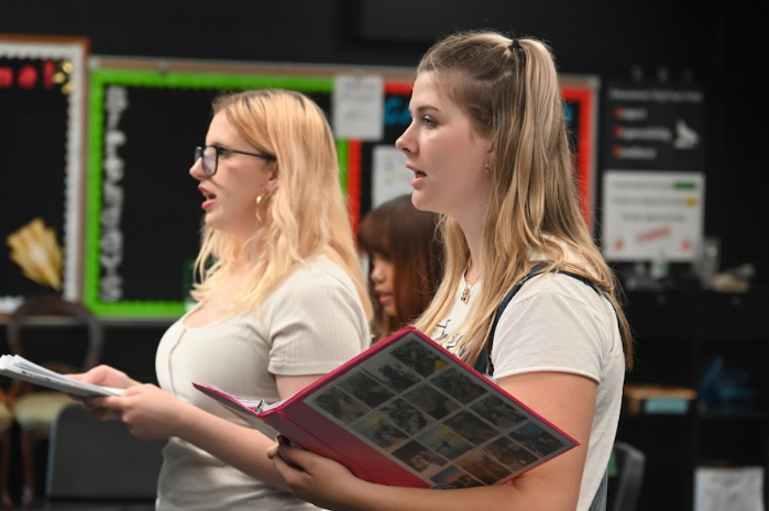 (From L to R) Senior Sophia Hillstead and sophomore Amelia Probst work together to tell the history of Hill House in a complex movement piece.