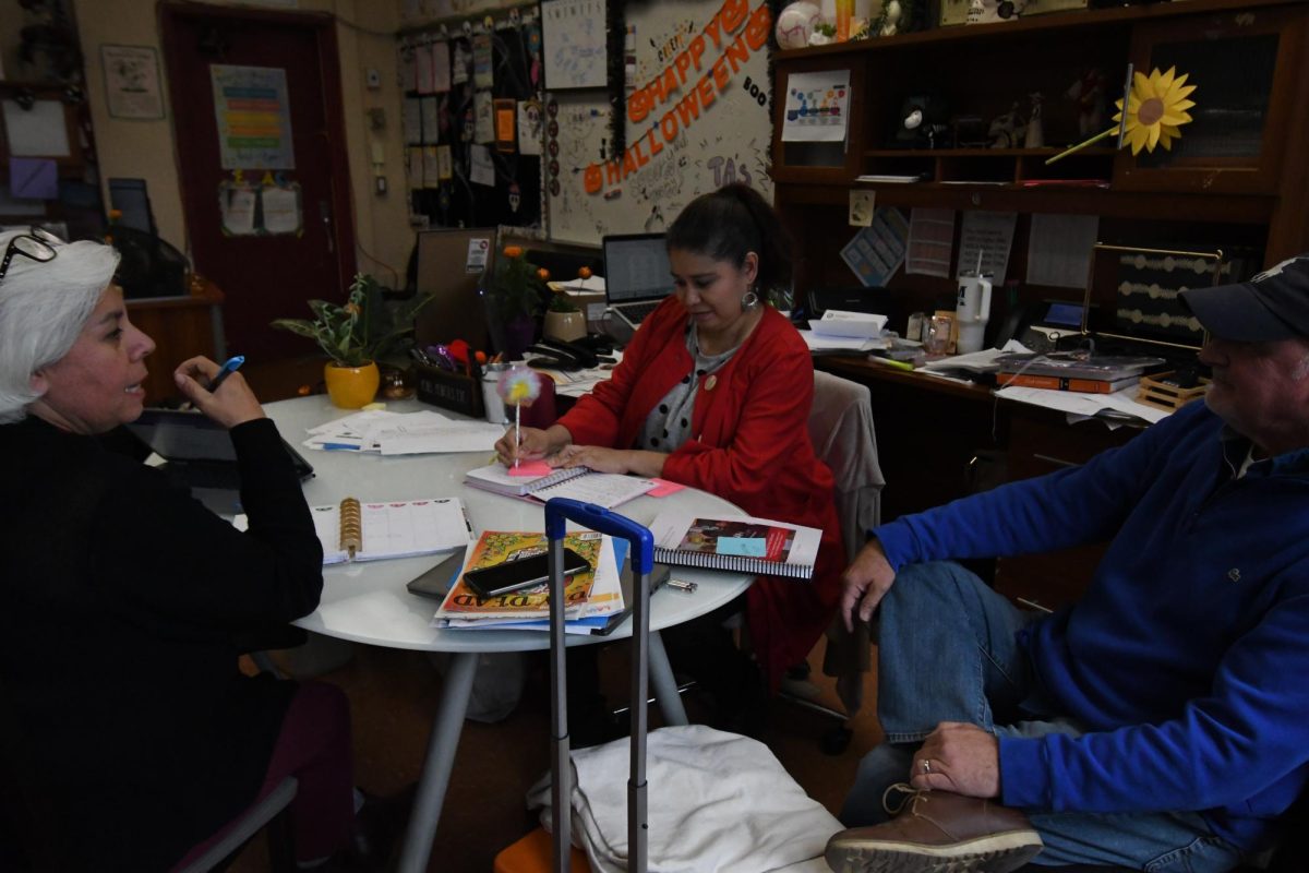 Instructional Coach, Ms. Montes De Oca, Emergent Bilingual Coordinator, Ms.Martinez  and English teacher Mr. Peterson (L-R) meeting in the Bilingual Office.