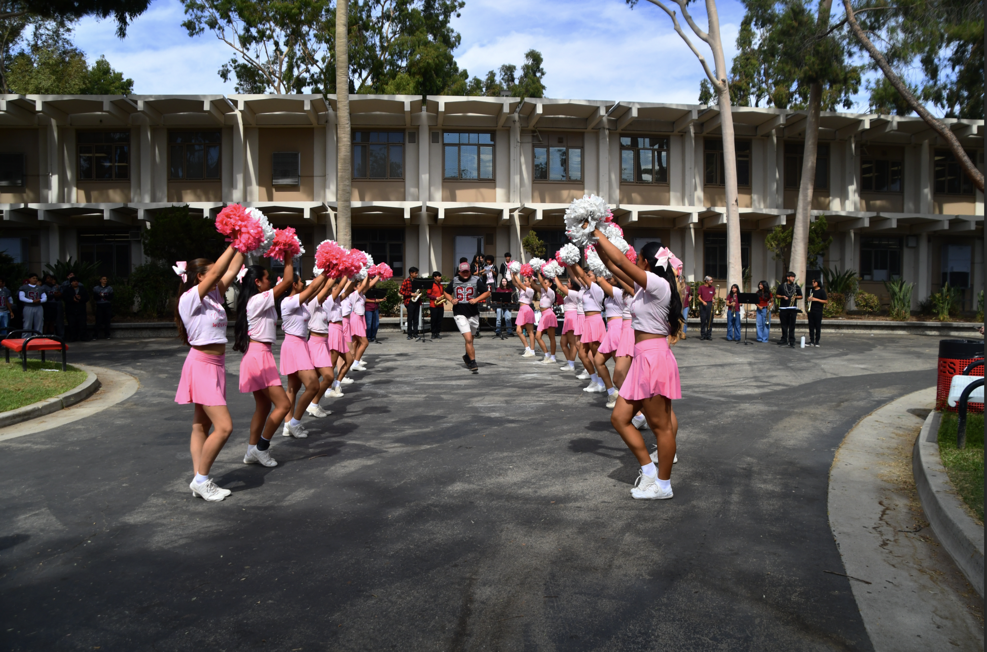 PLAY FOR AWARENESS | The football teams made their entrance through a tunnel of cheerleaders. Later at the football game, the team wore pink socks as they played against Reseda. After winning 38-0, pink confetti rained down on the bleachers as the students celebrated the team's victory.