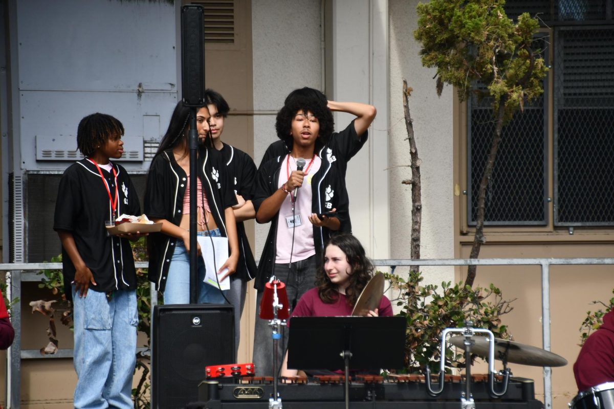 READY TO RALLY | Senior Elijah Loox from Associated Student Body (ASB) starts off the pep rally, announcing information about the game to the students. The students coordinated the event with band, cheer and the football teams to make sure the event was a success.