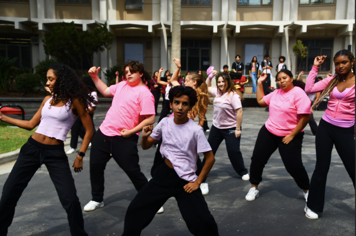 GOOD RHYTHM | Junior Armando Pacheco takes center stage for a section of the dance, hitting beats in sync with the dancers around him. The group gave a high-energy performance, with the crowd cheering as they watched.