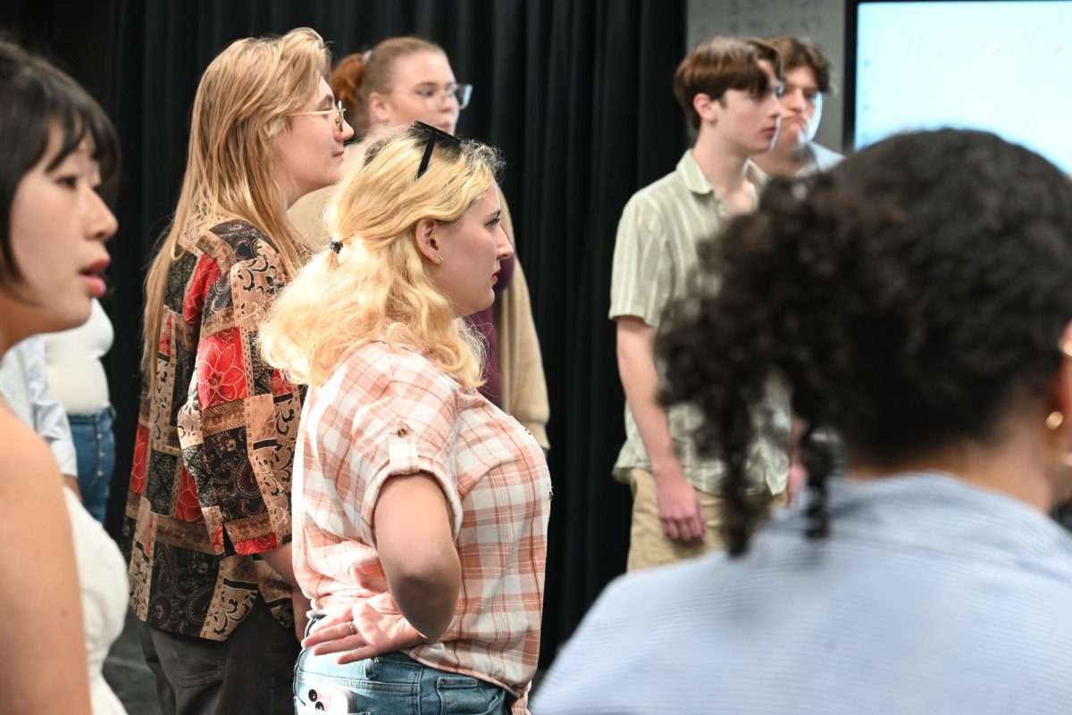 Ami Singer and other auditioners listen attentively to Mr. Baldrige's instructions and feedback