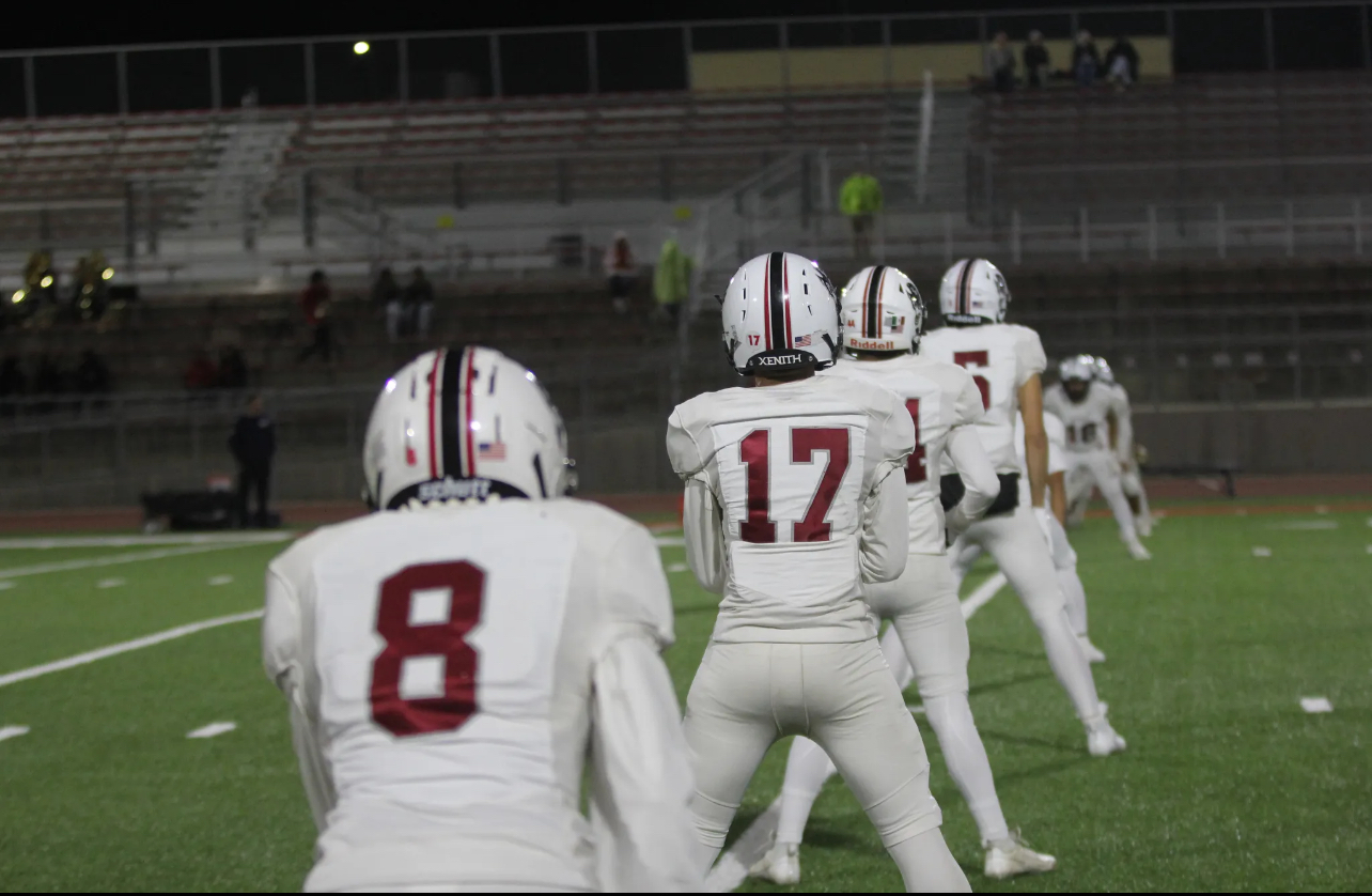 Wolves stretch on the field as they get ready to tackle the Taft Toreadors. 