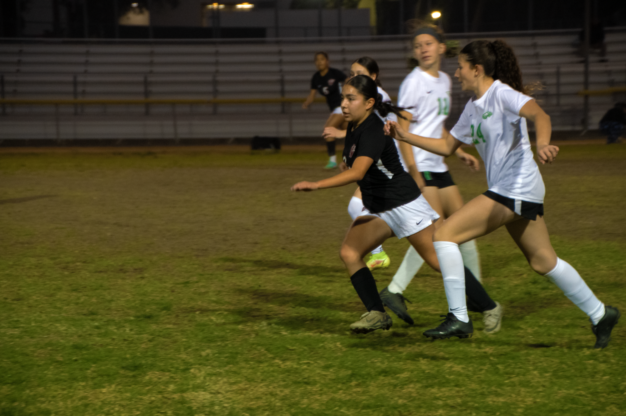 #8 Kimberly Cortez running through three Eagle Rock defenders