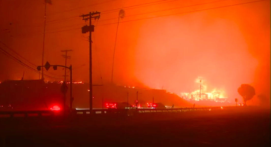 Blazing wildfires engulf Los Angeles neighborhoods as relentless winds spread flames, leaving destruction and chaos in their path.